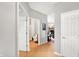 Inviting hallway with neutral paint, wood floors, and views into the living spaces at 7312 Drum Castle Ct, Indianapolis, IN 46259