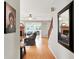Neutral hallway with wood floors, and views into the living spaces and the stairs at 7312 Drum Castle Ct, Indianapolis, IN 46259