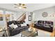 Spacious living room with wood floors, comfortable seating, and a view into the kitchen at 7312 Drum Castle Ct, Indianapolis, IN 46259