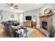 Comfortable living room featuring wood floors, a brick fireplace, and ample seating at 7312 Drum Castle Ct, Indianapolis, IN 46259