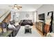 Bright and open living room with wood floors, a ceiling fan, and plenty of seating at 7312 Drum Castle Ct, Indianapolis, IN 46259