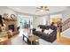 Inviting living room with a brick fireplace, ceiling fan, hardwood floors, and plenty of natural light at 7312 Drum Castle Ct, Indianapolis, IN 46259