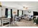 Inviting living room featuring a comfortable seating area, modern ceiling fan, and lots of natural light at 7312 Drum Castle Ct, Indianapolis, IN 46259