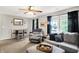 Bright living room showcasing comfortable seating, a decorative mirror, and large windows offering a serene view at 7312 Drum Castle Ct, Indianapolis, IN 46259