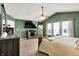 Bright bedroom boasts a ceiling fan, a full-length mirror, and large windows with natural light at 7312 Drum Castle Ct, Indianapolis, IN 46259
