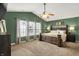 Serene main bedroom with neutral tones, a large bed, and ample natural light from the window at 7312 Drum Castle Ct, Indianapolis, IN 46259
