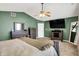 Spacious bedroom featuring a ceiling fan, dark wood furniture and a large-screen TV at 7312 Drum Castle Ct, Indianapolis, IN 46259