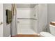 This shower features grab bars, a shower curtain, a shower head, and a built-in seat at 7312 Drum Castle Ct, Indianapolis, IN 46259