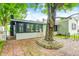 Spacious backyard with brick patio and large shade tree at 7414 Mendenhall Rd, Camby, IN 46113