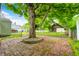 Spacious backyard with brick patio and large shade tree at 7414 Mendenhall Rd, Camby, IN 46113