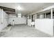 Unfinished basement offers plenty of space for storage, with painted walls and concrete floor at 7414 Mendenhall Rd, Camby, IN 46113