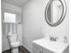 Bright bathroom featuring a vanity with gray cabinets, a large mirror, and a white toilet at 7414 Mendenhall Rd, Camby, IN 46113