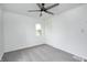 Neutral bedroom with light gray carpet, white walls, ceiling fan and a closet at 7414 Mendenhall Rd, Camby, IN 46113