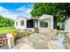 Charming home featuring a stone patio, landscaped garden beds, and a decorative fountain at 7414 Mendenhall Rd, Camby, IN 46113