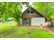 Backyard garage features an A-frame roof and a unique double door at 7414 Mendenhall Rd, Camby, IN 46113