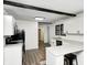 Modern kitchen with white cabinets, black hardware, stainless steel appliances, and countertop seating at 7414 Mendenhall Rd, Camby, IN 46113