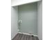 Unfinished laundry room features gray wood-look flooring and updated utility hookups at 7414 Mendenhall Rd, Camby, IN 46113