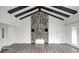 Cozy living room features a striking stone fireplace, and exposed ceiling beams, creating a warm ambiance at 7414 Mendenhall Rd, Camby, IN 46113