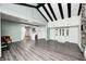 Open-concept living area showcases wood floors, and provides a seamless transition into the updated kitchen at 7414 Mendenhall Rd, Camby, IN 46113