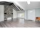Bright living room featuring a stone fireplace, wood floors, exposed beams, and ample natural light at 7414 Mendenhall Rd, Camby, IN 46113