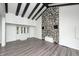 Bright living room featuring a stone fireplace, wood floors, exposed beams, and ample natural light at 7414 Mendenhall Rd, Camby, IN 46113