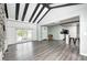Open-concept living area showcases wood floors, and provides a seamless transition into the updated kitchen at 7414 Mendenhall Rd, Camby, IN 46113