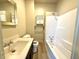 This bathroom features a full tub, neutral vanity, mirror, and shelving for easy access to toiletries at 745 N Tremont St, Indianapolis, IN 46222