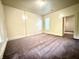 This bedroom is carpeted and boasts natural light, neutral colors, and an entryway to another room at 745 N Tremont St, Indianapolis, IN 46222