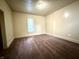 The carpeted bedroom features neutral walls, great lighting, and access to other rooms in the house at 745 N Tremont St, Indianapolis, IN 46222
