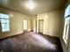 Cozy bedroom featuring plush carpeting, a closet, and abundant natural light from the windows at 745 N Tremont St, Indianapolis, IN 46222