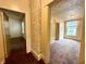 Hallway accented by exposed brick with access to multiple rooms, each naturally lit by windows at 745 N Tremont St, Indianapolis, IN 46222