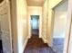 Bright hallway with neutral walls and access to multiple rooms, with neutral carpeting and lighting at 745 N Tremont St, Indianapolis, IN 46222