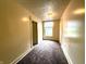 Neutral hallway with textured ceilings leads to rooms with natural light and doors throughout at 745 N Tremont St, Indianapolis, IN 46222