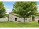 Spacious backyard with a well-manicured lawn, mature trees, and a patio area at 764 Port Dr, Avon, IN 46123
