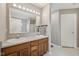 Bathroom featuring double sinks, wooden cabinetry, and large mirror with vanity lighting at 764 Port Dr, Avon, IN 46123