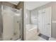 Bathroom featuring bathtub with shower, glass doors, and neutral wall color at 764 Port Dr, Avon, IN 46123