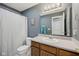Well-lit bathroom featuring a large mirror, wood vanity, and shower with a white curtain at 764 Port Dr, Avon, IN 46123