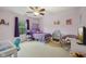 Bedroom with purple decor, ceiling fan, and a study area with a white desk at 764 Port Dr, Avon, IN 46123