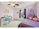 Bedroom featuring purple decor, a ceiling fan, and a cozy canopy bed at 764 Port Dr, Avon, IN 46123