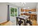Eat-in kitchen with a dark wood table and chairs, leading to a patio with a picnic table at 764 Port Dr, Avon, IN 46123