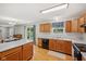 Bright kitchen with a breakfast bar, wood cabinets, and a sliding door that opens to the backyard at 764 Port Dr, Avon, IN 46123