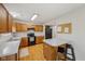 This kitchen has wood cabinets, neutral countertops, and a view into the dining area at 764 Port Dr, Avon, IN 46123