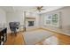 Cozy room with brick fireplace, hardwood floors, and modern ceiling fan at 764 Port Dr, Avon, IN 46123