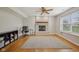 Cozy room with brick fireplace, hardwood floors, and modern ceiling fan at 764 Port Dr, Avon, IN 46123