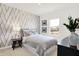 Bedroom featuring gray bed and geometric accent wall at 8781 Marietta Ln, McCordsville, IN 46055