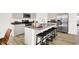 Modern kitchen island with bar stools and stainless steel appliances, offering ample seating and storage at 8781 Marietta Ln, McCordsville, IN 46055