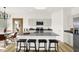 Modern kitchen featuring a large island with bar stools, stylish lighting, and stainless steel appliances at 8781 Marietta Ln, McCordsville, IN 46055