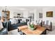 Well-lit living area with modern decor, comfortable seating, and an open layout, connecting to the kitchen at 8781 Marietta Ln, McCordsville, IN 46055