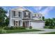 Charming two-story home with stone accents, gray siding, white trim, and a two-car garage at 8784 Alexander Ridge Dr, McCordsville, IN 46055