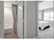 Bathroom and bedroom with a white-tiled shower and neutral walls and textiles at 8856 Alexander Ridge Dr, McCordsville, IN 46055